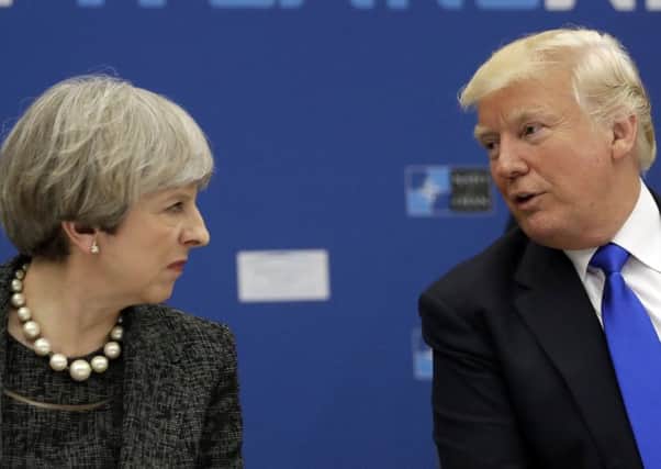 (FILES) This file photo taken on January 27, 2017 shows US President Donald Trump and British Prime Minister Theresa May walking to a press conference at the White House in Washington, DC.
Britain was reeling Thursday after US President Donald Trump castigated Prime Minister Theresa May over her rebuke to him for posting anti-Muslim tweets, but the government sought to play down the row. / AFP PHOTO / Brendan SmialowskiBRENDAN SMIALOWSKI/AFP/Getty Images