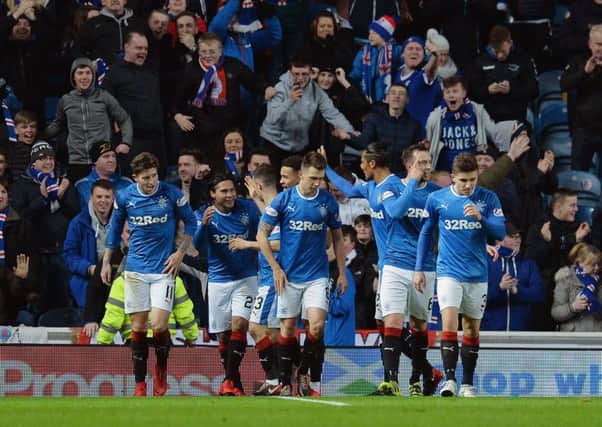 Rangers players celebrate after Carlos Pena doubles their lead. Picture: PA