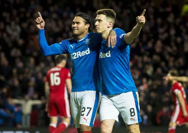 Ryan Jack, right, celebrates with Carlos Pena after the latter doubled Rangers' advantage. Picture: SNS