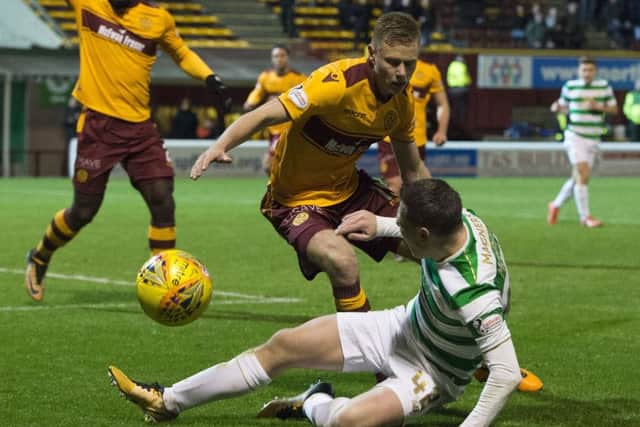 Celtic's Callum McGregor wins a penalty as he goes down under the challenge of Andy Rose. Picture: Ross Parker/SNS