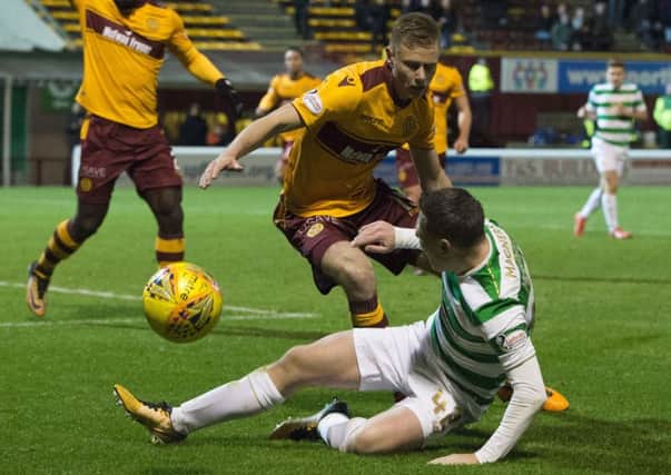 Celtic's Callum McGregor wins a penalty as he goes down under the challenge of Andy Rose. Picture: Ross Parker/SNS