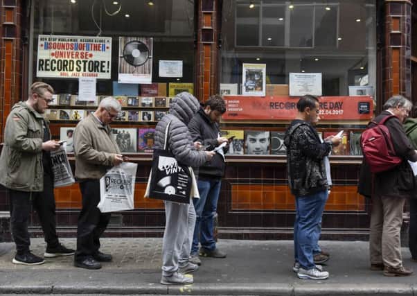 People queue outside a record shop. Rex/Shutterstock