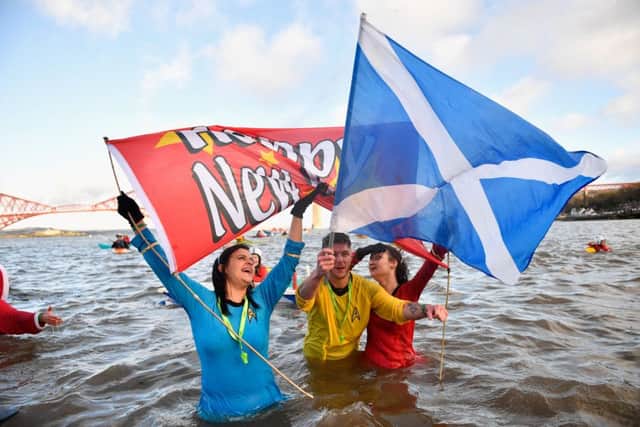 New Year swimmers in front of the Forth Rail Bridge during the annual Loony Dook Swim in the River Forth. Picture: Jeff J Mitchell/Getty Images