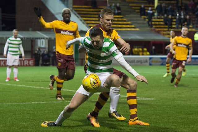 Callum McGregor wins a penalty as he goes down under a challenge of Andy Rose. Picture: SNS