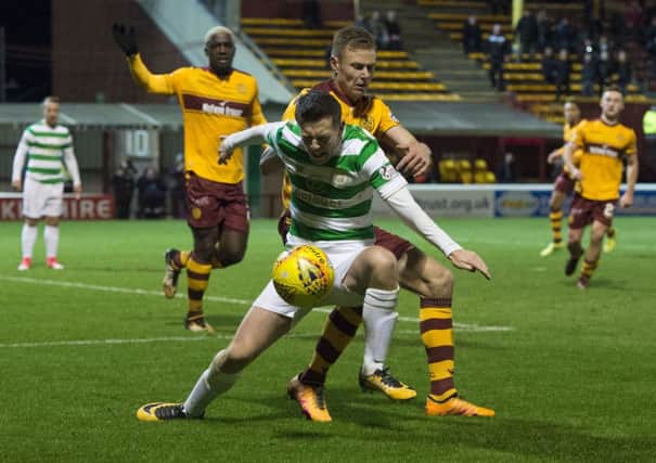Callum McGregor wins a penalty as he goes down under a challenge of Andy Rose. Picture: SNS