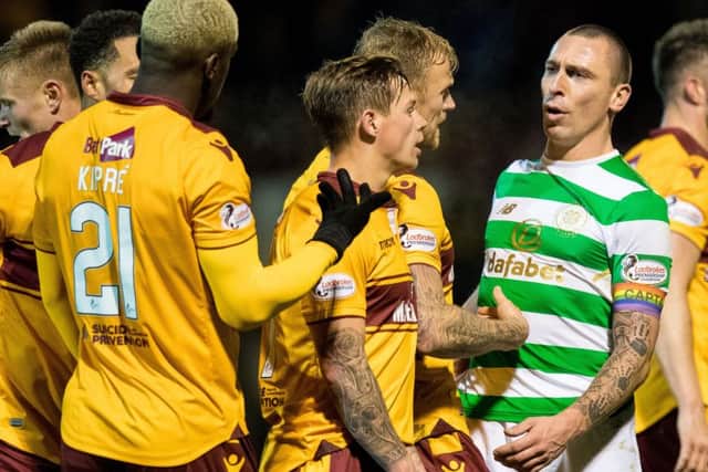 Scott Brown and Motherwell's Cedric Kipre exchange words at full time after the 1-1 draw at Fir Park. Picture: SNS Group