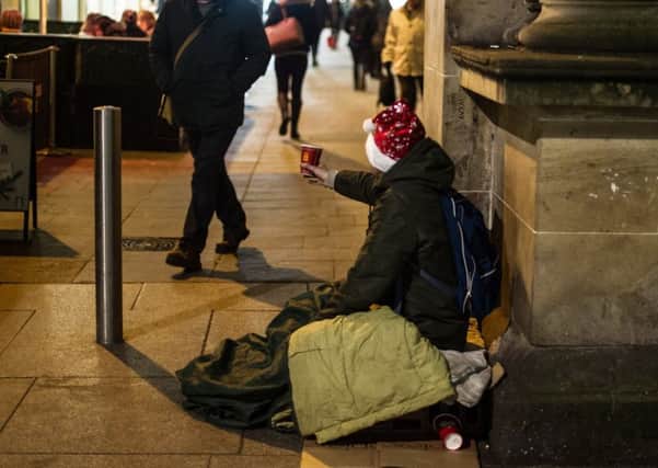A man begs passersby for money in Royal Exchange Square. Picture: John Devlin