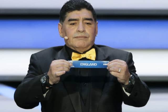 Argentina legend Diego Maradona holds up England at the 2018 soccer World Cup draw. Picture: AP
