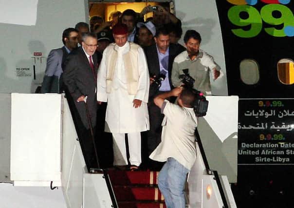 Megrahi, left, holds the hand of Libyan leader Colonel Gaddafis son, Seif al-Islam, on his arrival in Tripoli in 2009. 
Picture: Getty