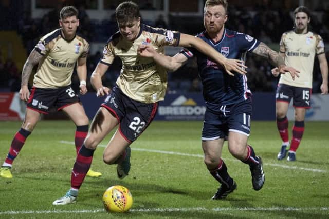Dundee's Jack Hendry (left) chases down the ball while under pressure from Ross County's Craig Curran. Picture: SNS/Bill Murray