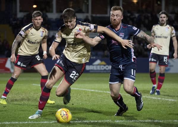 Dundee's Jack Hendry (left) chases down the ball while under pressure from Ross County's Craig Curran. Picture: SNS/Bill Murray