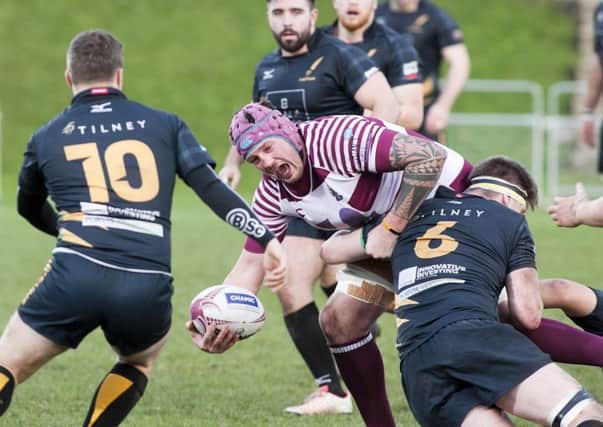 Watsonian's Craig Borthwick is tackled by Stephen Ainslie. Picture: Alistair Linford