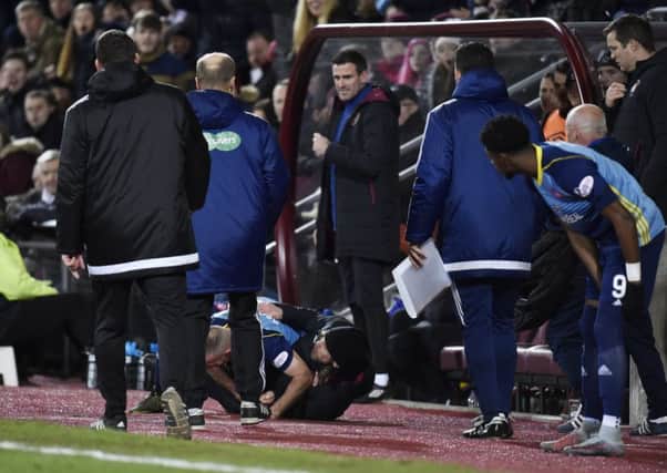 Hearts assistant coach Austin MacPhee and Hamilton's Darian Mackinnon fall to the ground. Picture: SNS.