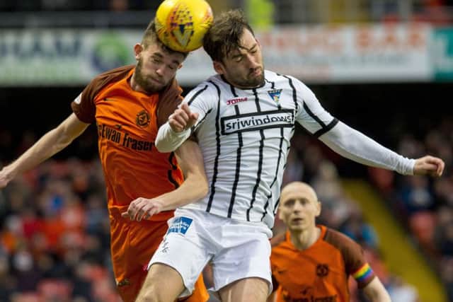 Dundee Uniteds Sam Stanton goes head to head with Michael Paton. Picture: SNS.