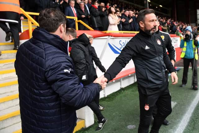 Derek McInnes, right, shakes hands with Graeme Murty after Aberdeen's loss against Rangers. Picture: SNS
