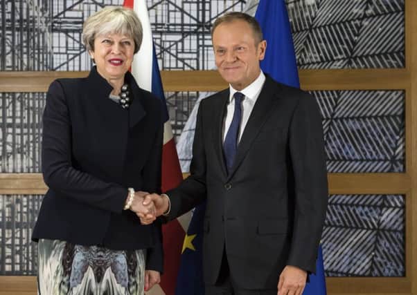 All smiles: Theresa May shakes hands with European Council President Donald Tusk (Picture: AP)
