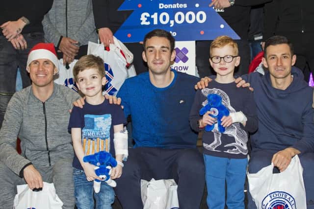 Rangers players, from left, Kenny Miller, Lee Wallace and Jason Holt met  Bryce Barron, 6, and James Lumsden, 5 ,at the Royal Hospital for Children in Glasgow. Picture: SNS.