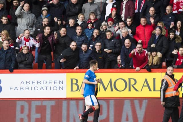 Jack gets plenty of stick from Aberdeen fans as he leaves the field following his red card. Picture: SNS Group