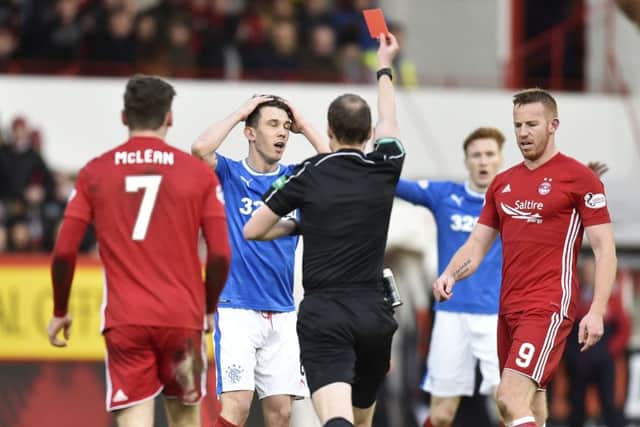 Ryan Jack (centre) is shown a red card by referee Willie Collum. Picture: SNS Group