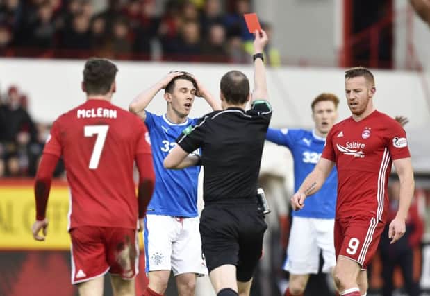 Ryan Jack (centre) is shown a red card by referee Willie Collum. Picture: SNS Group