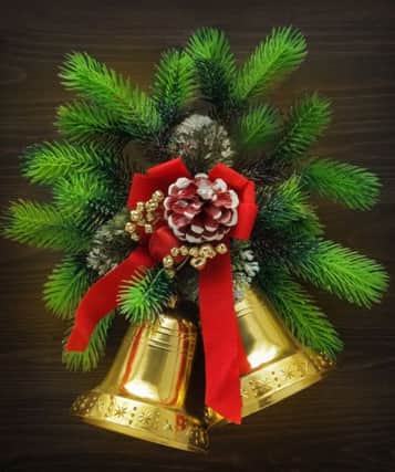 Christmas bells with red ribbon and pine twigs