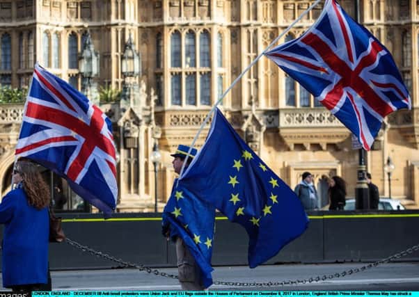 Anti-Brexit campaigners wave EU and Union flags outside the Westminster Parliament. (Picture: Getty)
