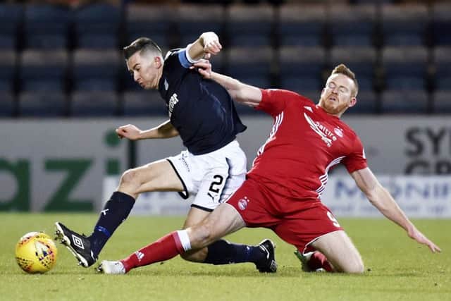 Dundee's Cammy Kerr (L) and Aberdeen's Adam Rooney vie for the ball. Picture: SNS Group