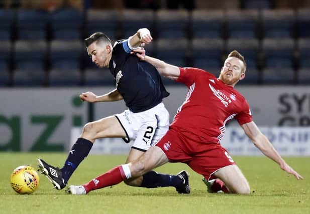 Dundee's Cammy Kerr (L) and Aberdeen's Adam Rooney vie for the ball. Picture: SNS Group