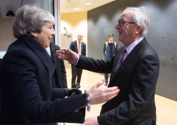 All smiles: EU President Jean-Claude Juncker greets Theresa May at the EU Commission in Brussels. (Picture: PA)