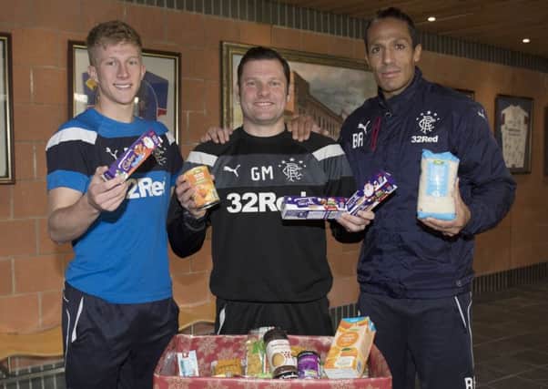 Bruno Alves, right, joins Rangers team-mate Ross McCrorie, left, and interim manager Graeme Murty to help promote the Rangers Charity Foundation's food bank collection before Saturday's game with Ross County. Fans are asked to bring non-perishable food items to a collection point outside the megastore. Picture: Craig Foy/SNS