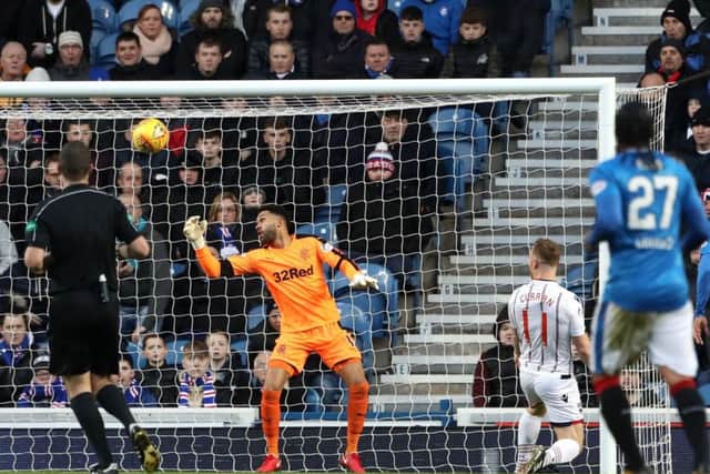 Craig Curran puts Ross County in front at Ibrox. Picture: PA