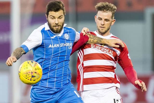Richard Foster battles for possession with Hamilton's David Templeton. Picture: SNS