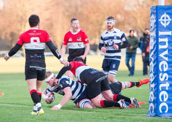 Adam Sinclair crashes over for a try for Heriot's against Hawks. Picture: Ian Georgeson