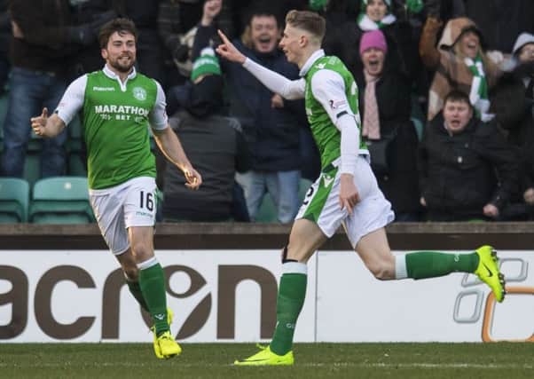 Lewis Stevenson goes to greet Oli Shaw after his equaliser for Hibs. Picture: SNS
