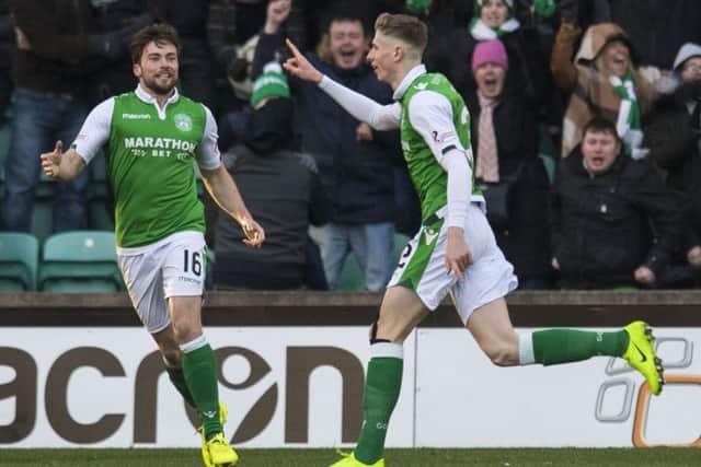 Lewis Stevenson goes to greet Oli Shaw after his equaliser for Hibs. Picture: SNS