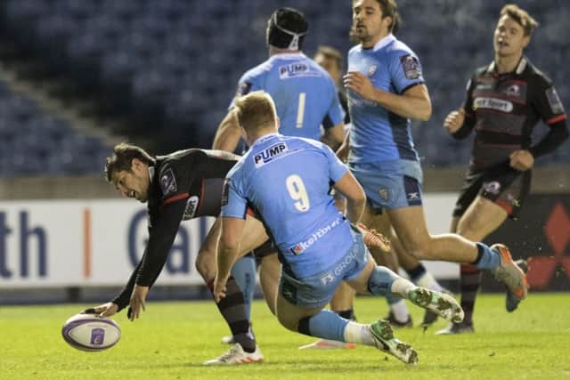 Edinburgh's Phil Burleigh touches down for the first of his two tries. Picture: SNS