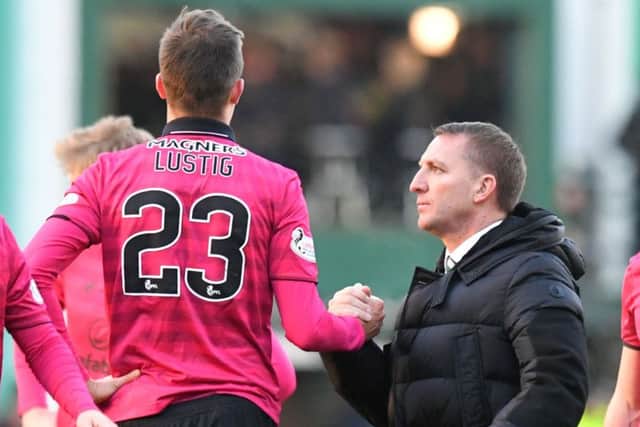 Brendan Rodgers thanks Mikael Lustig for the late goal-line clearance that prevented Hibs' Oli Shaw ending Celtic's unbeaten run. Picture: SNS