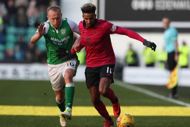 Scott Sinclair holds off Dylan McGeouch during the 2-2 draw at Easter Road on Sunday. Picture: PA