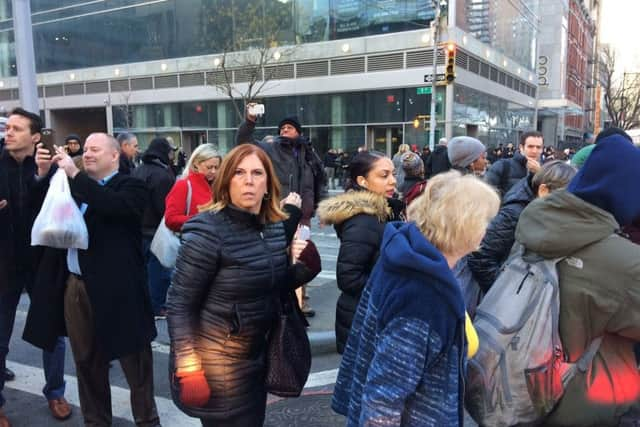 A crowd moves past police responding to a report of an explosion near Times Square on Monday. Picture; AP