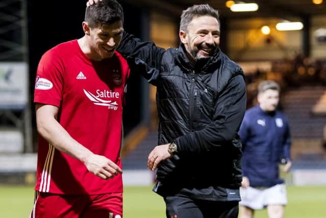 Derek McInnes congratulates goalscorer Scott McKenna after Aberdeens win over Dundee on Friday night. Picture: Roddy Scott/SNS