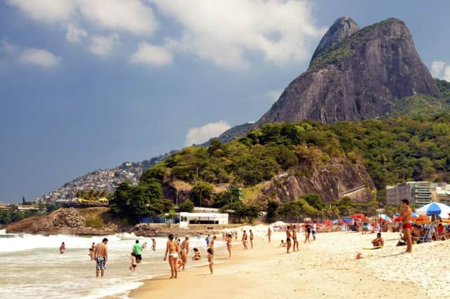 Rio de Janeiro, Brazil, 3 March 2012  : Ipanema beach in Rio de Janeiro with people swimming in the sea, sunbathing and relaxing in the sun