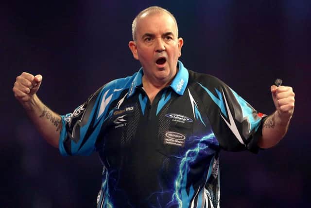 Phil Taylor celebrates yet another victory in a career that has seen him amass Â£7m in prize money. Picture: Steven Paston/PA Wire