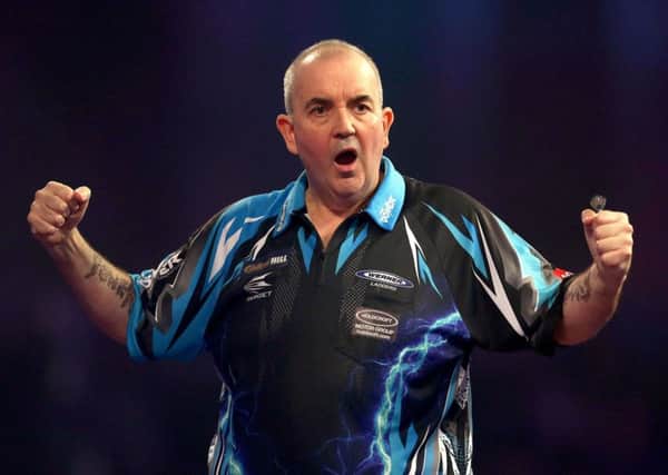 Phil Taylor celebrates yet another victory in a career that has seen him amass Â£7m in prize money. Picture: Steven Paston/PA Wire