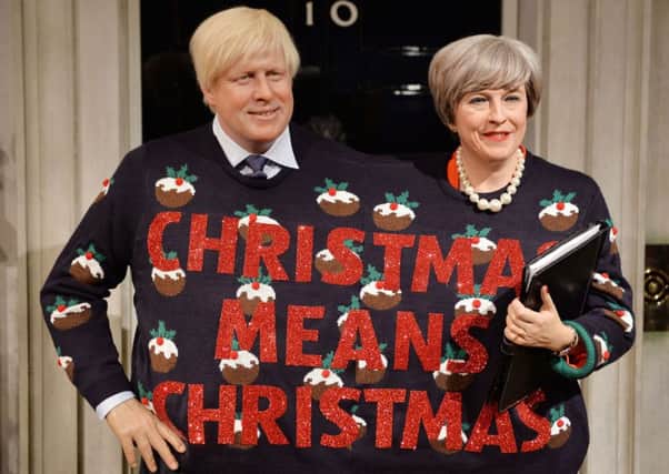 Madame Tussauds imagines Boris Johnson and Theresa May in a Christmas jumper made for two. Picture: PA