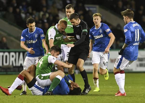 Darren McGregor (second from left) gets tangled up with Rangers striker Eduardo Herrera as team-mates and the referee rush in. Picture: SNS