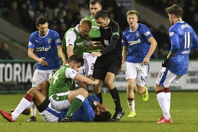 Darren McGregor (second from left) gets tangled up with Rangers striker Eduardo Herrera as team-mates and the referee rush in. Picture: SNS