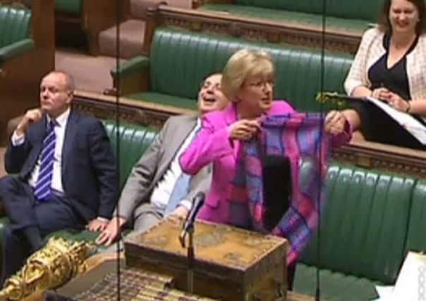 Commons Leader Andrea Leadsom dons a pink tartan scarf at the despatch box in the House of Commons. Picture: PA