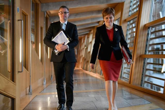 Finance Secretary Derek Mackay and Scotland's First Minister Nicola Sturgeon, arrive at the Scottish Parliament. (Photo by Jeff J Mitchell/Getty Images)