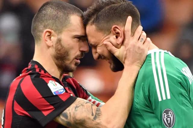AC Milan's Leonardo Bonucci, left, consoles goalkeeper Gianluigi Donnarumma during the Italian Cup game against Hellas Verona. Picture: Daniel Dal Zennaro/ANSA via AP
