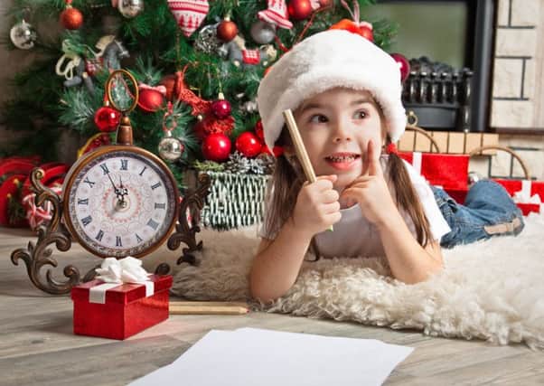 A girl thinks about what she would like to ask Santa to bring this year (Picture: Getty)